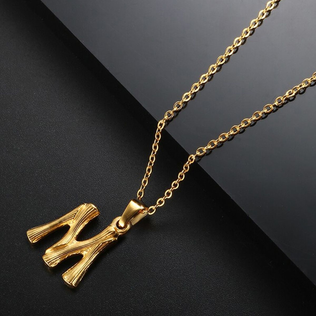 Small gold pendant with letter M | JewelryAndGems.eu